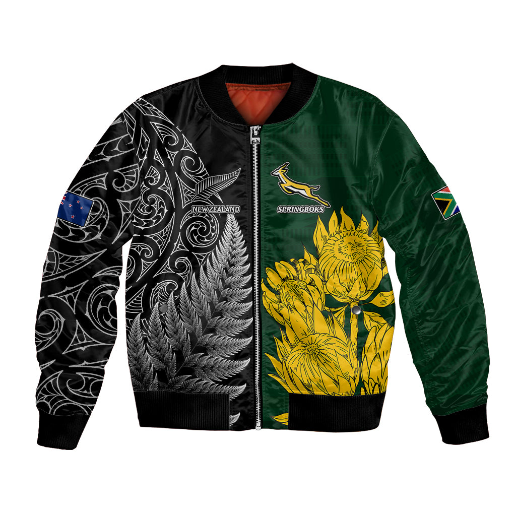 Green and black satin bomber jacket with zip front and yellow protea/fern graphics.