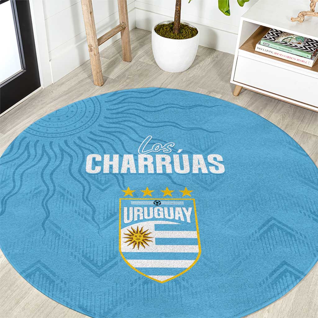 Sky blue round carpet with Los Charruas text and Uruguay crest