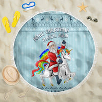Turquoise round beach blanket with fringe, featuring Santa and unicorn graphic