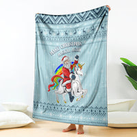 Turquoise Christmas blanket with unicorn and Santa graphic, decorative border