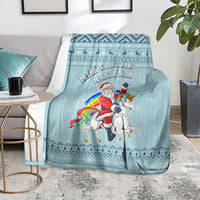 Turquoise unicorn Christmas blanket on floor with visible border and “Magical Again” text