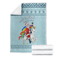 Turquoise blanket folded with unicorn and Santa graphic, boxed presentation