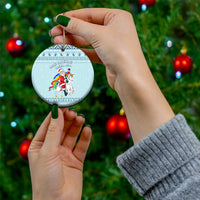 Turquoise round ceramic Christmas ornament with unicorn and Santa, held by hand