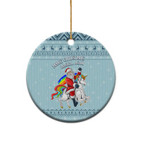 Turquoise round ceramic Christmas ornament with unicorn and Santa graphic, hanging loop