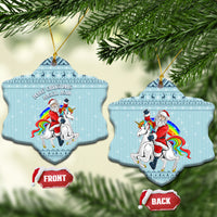 Turquoise ceramic Christmas bell ornament with unicorn and Santa, hanging on gold loop