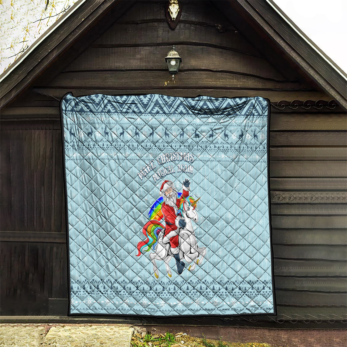 Turquoise quilt hanging on wall with unicorn graphic and 'Make Christmas Magical Again' lettering