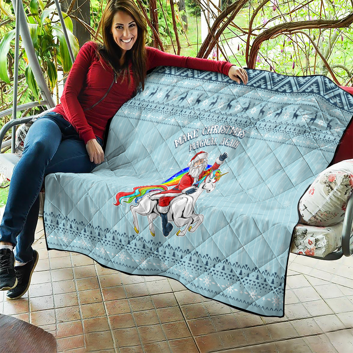 Turquoise quilt draped over sofa with unicorn rider graphic, diamond quilting and festive trim