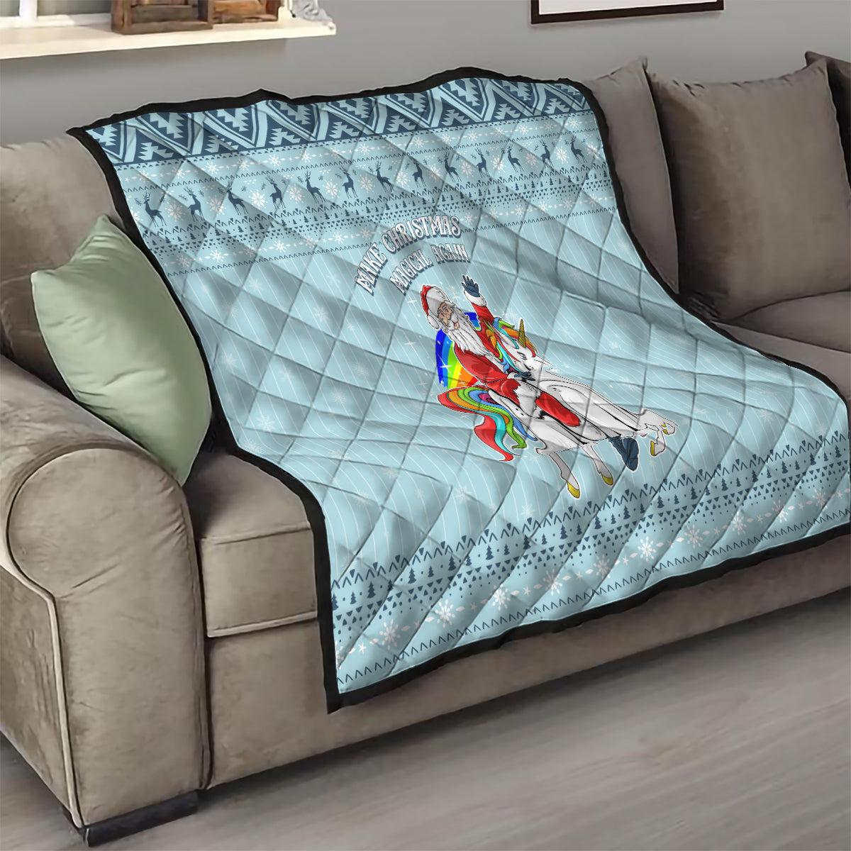 Turquoise throw quilt on couch with unicorn graphic and arched 'Make Christmas Magical Again' text