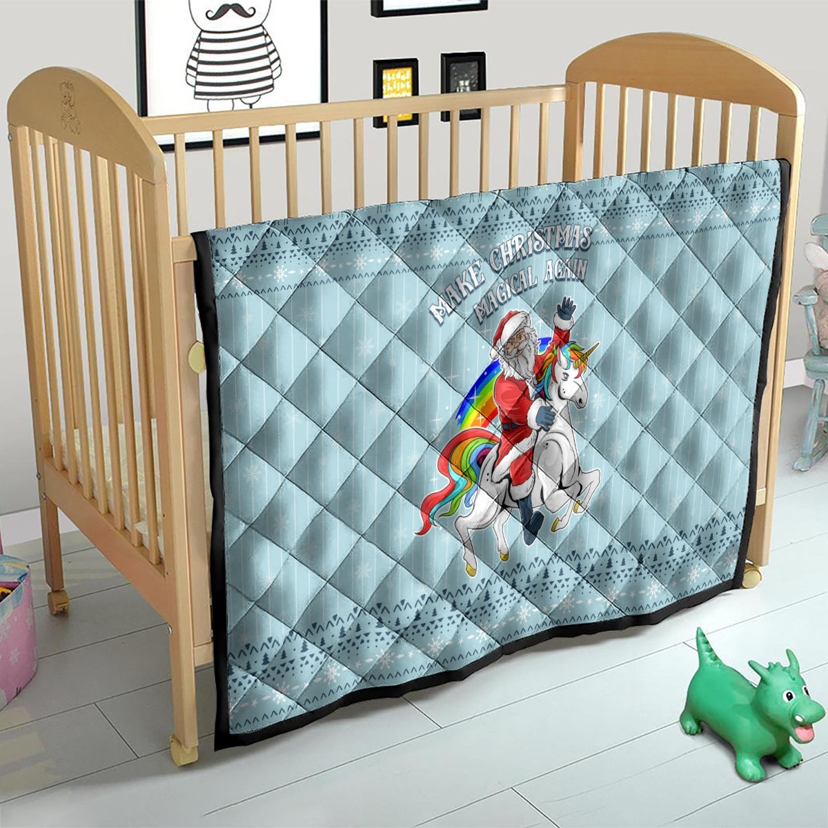 Turquoise quilt on crib with centered unicorn rider graphic and 'Make Christmas Magical Again' text