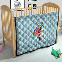 Turquoise quilt on crib with centered unicorn rider graphic and 'Make Christmas Magical Again' text
