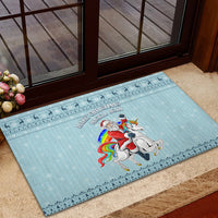 Turquoise rubber doormat with Santa and unicorn graphic and festive border design