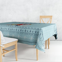 Turquoise Christmas unicorn tablecloth draped over a dining table