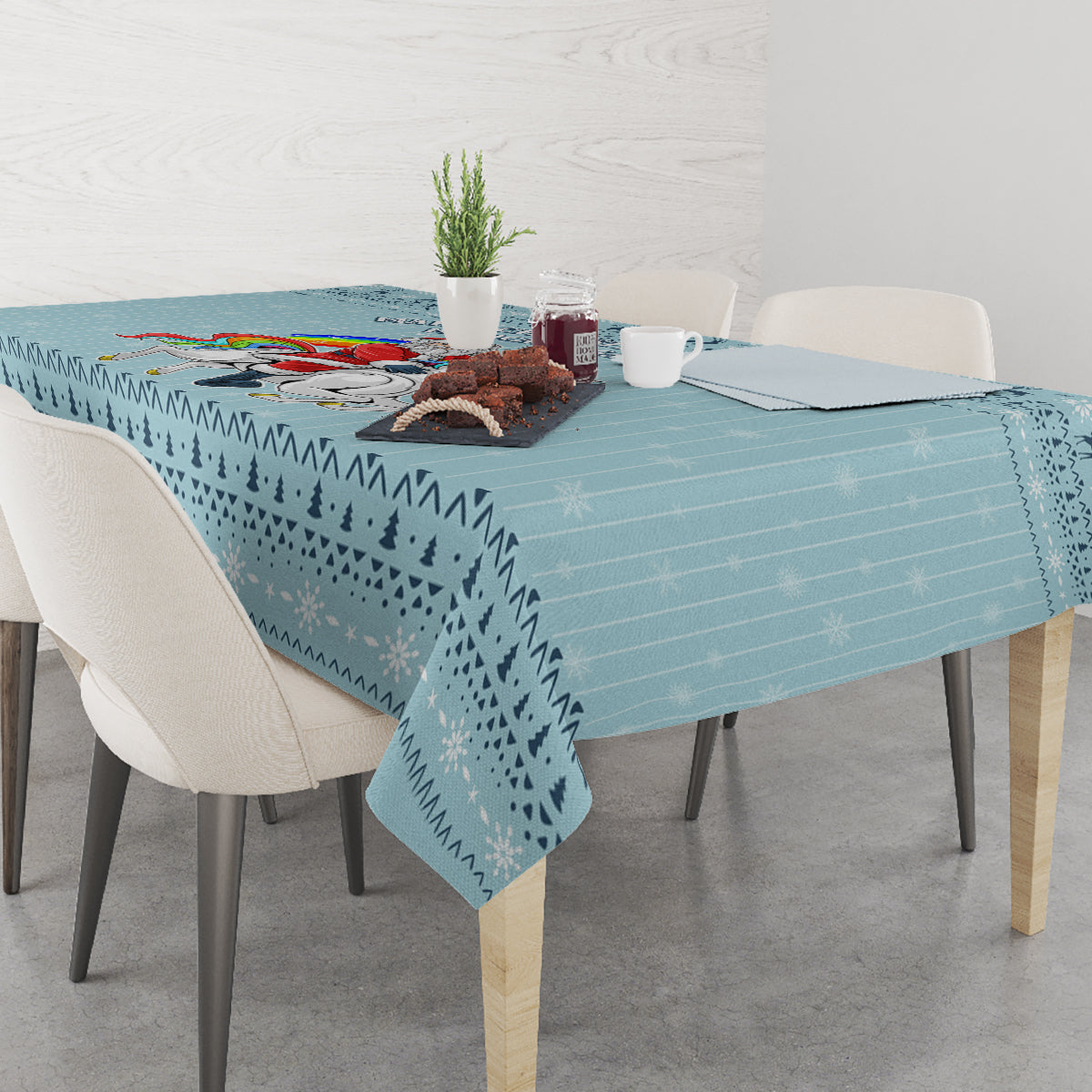 Turquoise tablecloth with Christmas unicorn and winter icons on the table
