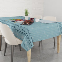 Turquoise tablecloth with Christmas unicorn and winter icons on the table