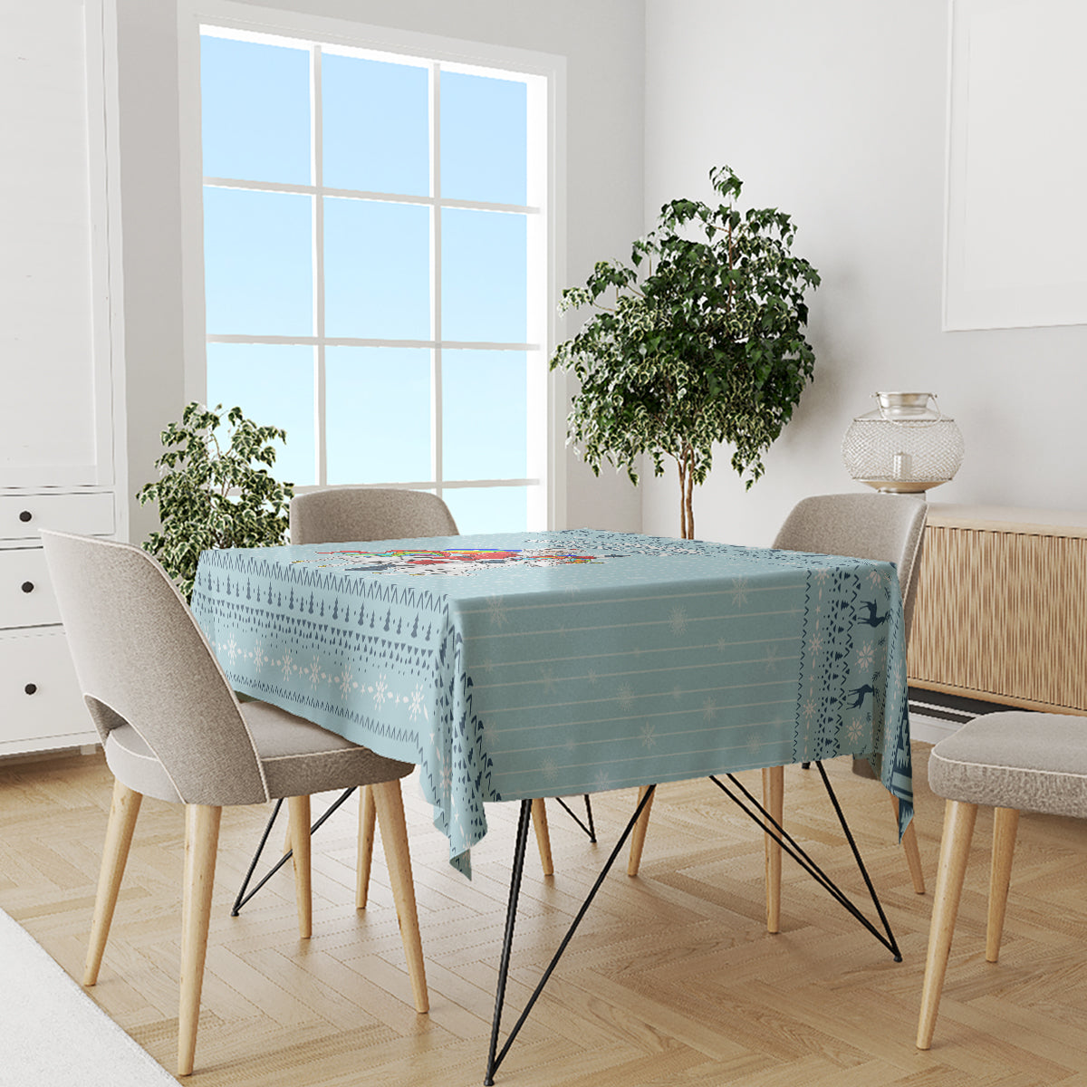Turquoise unicorn Christmas tablecloth on a dining table with chairs