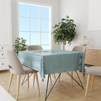 Turquoise unicorn Christmas tablecloth on a dining table with chairs