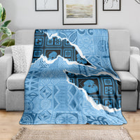 Turquoise patterned throw blanket with island outline and blue ornamental motifs
