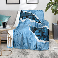 Turquoise map-style blanket throw with white border-edged silhouette and blue icons