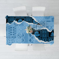 Turquoise tapa-style Christmas tablecloth with blue patchwork pattern and floral accents