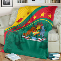 Green blanket with Grenada flag stars and coat-of-arms emblem, spread on couch