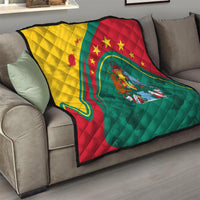Colorful quilt with star patterns and shield-like emblem, green red and yellow