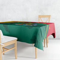 Tablecloth draped on table, green fabric with red edge and gold star border