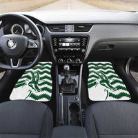 Front car mats with green zigzag pattern and bird logo on white backing