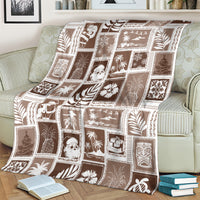 Brown and white patchwork blanket with repeating square motifs, draped across a couch