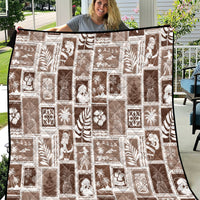 Brown and white patchwork quilt with repeating tropical motifs and textured seams