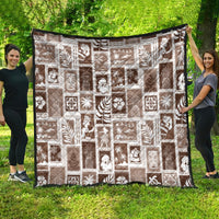 Brown throw quilt featuring white patch blocks with tropical symbols and borders