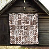 Brown patchwork quilt with white tropical icons in square blocks, neatly edged