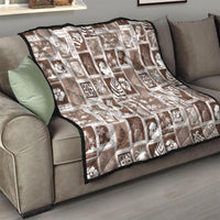 Brown throw quilt on sofa with white patchwork squares and tropical motif prints