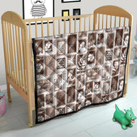 Brown and white patchwork baby quilt with repeating tropical motifs in square blocks
