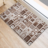 Brown doormat with white rectangular patchwork holiday symbols arranged in rows