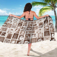 Brown patchwork sarong with white island icon blocks, draped wide back view