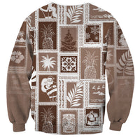 Brown crewneck sweatshirt, patchwork blocks with ornaments, gifts, and festive figures