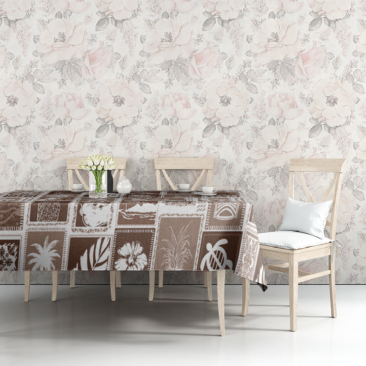 Brown patchwork tablecloth with festive retro motifs on table against a light wall