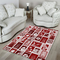 Red patchwork area rug with white holiday motifs arranged in a grid of squares