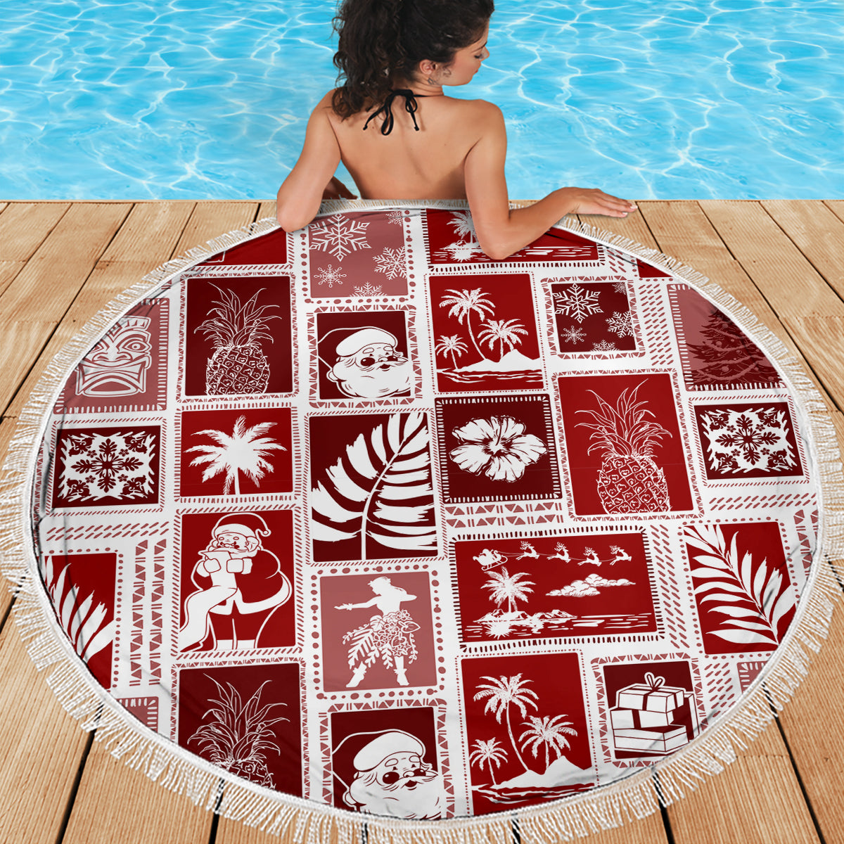 Red round beach blanket with white-fringe edge and patchwork winter tropical motifs