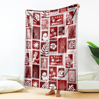 Red patchwork-style Christmas blanket with novelty scene and leaf motifs, rectangular throw