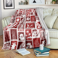 Red patchwork Christmas blanket spread over bed, shows square holiday and plant patterns