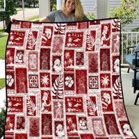 Red patchwork quilt with white holiday graphic squares and border