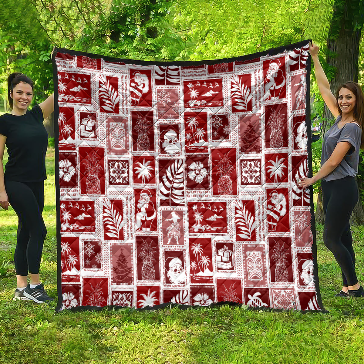 Red patchwork holiday quilt hanging outdoors with white motif squares