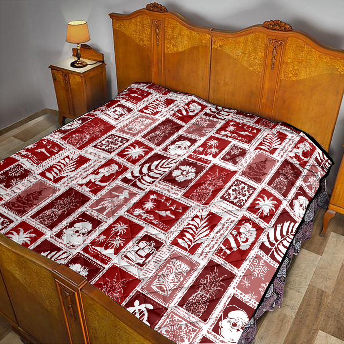 Red patchwork quilt with white patterned squares on a bed