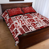 Red patchwork quilt with two holiday pillows, white embroidered-look square pattern