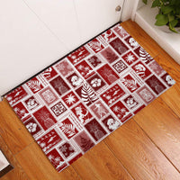 Red rubber doormat with white patchwork holiday patterns, rectangular edge trim