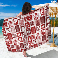 Red patchwork Christmas-style sarong with white square prints, draped over shoulders