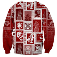 Red crewneck sweatshirt with white patchwork blocks of holiday motifs; long sleeves
