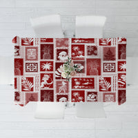 Red patchwork tablecloth with white holiday icons and square patterned blocks