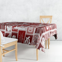 Red holiday patchwork tablecloth draped over rectangular dining table